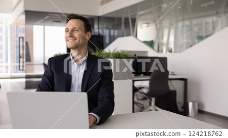 Ambitious business leader man working at laptop in modern office Ambitious business leader man working at laptop in modern office 124218762