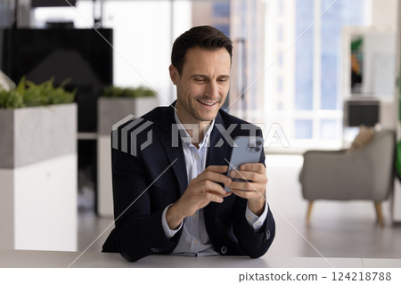 Positive confident Hispanic businessman using financial trading application Positive confident Hispanic businessman using financial trading application 124218788