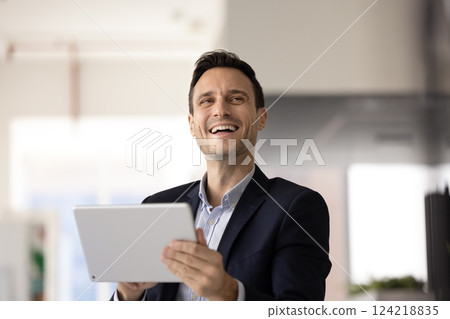 Happy business executive man using digital tablet for work 124218835