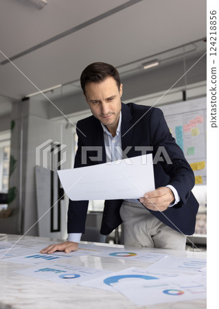 Pensive Hispanic business leader man thinking on financial investment strategy 124218856