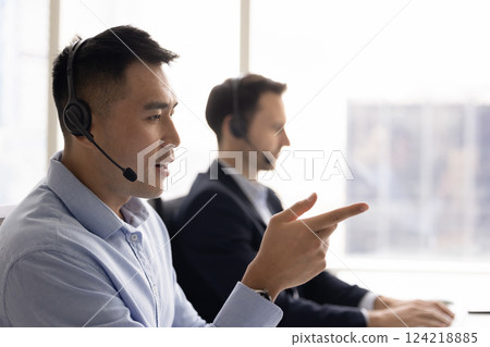 Asian contact center operator man talking on audio call 124218885