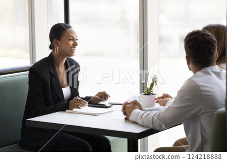African professional woman leads negotiations with couple in office 124218888