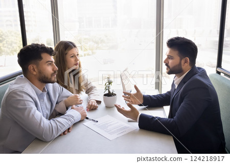 Couple having discussion with business consultant, realtor or financial advisor Couple having discussion with business consultant, realtor or financial advisor 124218917