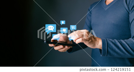 man using smartphone and touch icon social media for online marketing, work from anywhere. technology internet networking, playing social media and living on holiday concept. 124219151