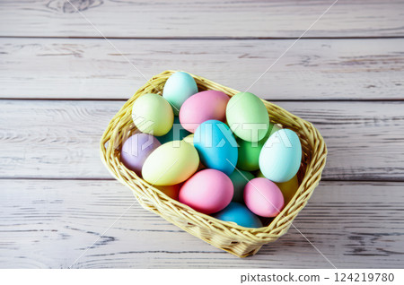Hand Painted Pastel Easter Eggs In Wicker Basket Close Up View Of Colorful Eggs On Simple Green Wooden Surface, Showcasing Easters Delight 124219780