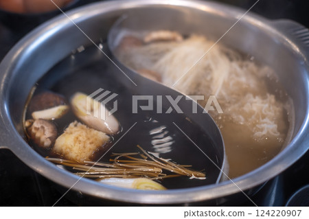 Hot pot with two types of soup, clear and shabu soup with vegetable Hot pot with two types of soup, clear and shabu soup with vegetable 124220907