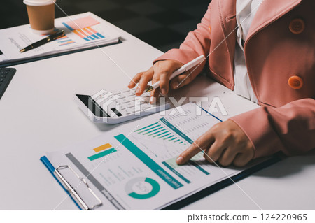 Cropped image of professional businesswoman working at her office via laptop, young female manager using portable computer device while sitting at modern loft, flare light, work process concept 124220965