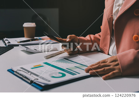 Cropped image of professional businesswoman working at her office via laptop, young female manager using portable computer device while sitting at modern loft, flare light, work process concept 124220976