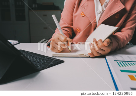 Cropped image of professional businesswoman working at her office via laptop, young female manager using portable computer device while sitting at modern loft, flare light, work process concept 124220995