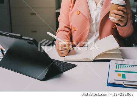 Cropped image of professional businesswoman working at her office via laptop, young female manager using portable computer device while sitting at modern loft, flare light, work process concept Cropped image of professional businesswoman working at her office via laptop, young female manager using portable computer device while sitting at modern loft, flare light, work process concept 124221002