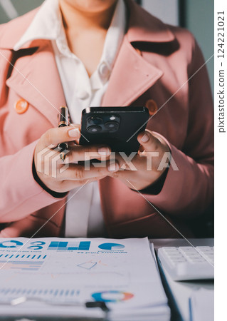 Cropped image of professional businesswoman working at her office via laptop, young female manager using portable computer device while sitting at modern loft, flare light, work process concept 124221021