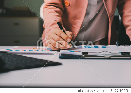 Cropped image of professional businesswoman working at her office via laptop, young female manager using portable computer device while sitting at modern loft, flare light, work process concept 124221023