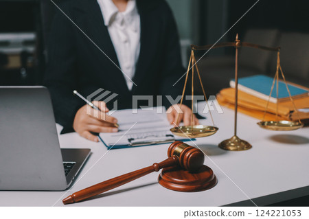 Judge gavel with Justice lawyers having team meeting at law firm background. Concepts of Law and Legal services. 124221053