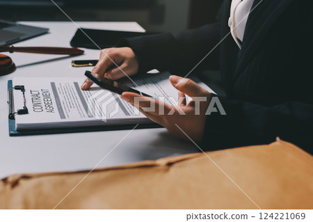 Judge gavel with Justice lawyers having team meeting at law firm background. Concepts of Law and Legal services. 124221069