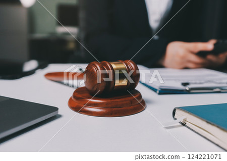 Judge gavel with Justice lawyers having team meeting at law firm background. Concepts of Law and Legal services. Judge gavel with Justice lawyers having team meeting at law firm background. Concepts of Law and Legal services. 124221071