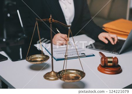 Judge gavel with Justice lawyers having team meeting at law firm background. Concepts of Law and Legal services. 124221079