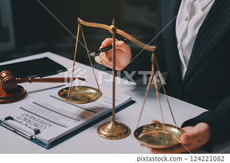 Judge gavel with Justice lawyers having team meeting at law firm background. Concepts of Law and Legal services. 124221082
