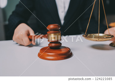 Judge gavel with Justice lawyers having team meeting at law firm background. Concepts of Law and Legal services. 124221085