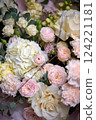 Delicate composition of white and pink roses in a basket 124221181
