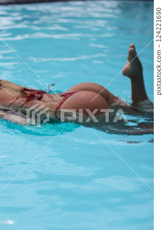 Enjoying the Art of Graceful Swimming in the Crystal Clear Pool Water during Summer Days Enjoying the Art of Graceful Swimming in the Crystal Clear Pool Water during Summer Days 124221690