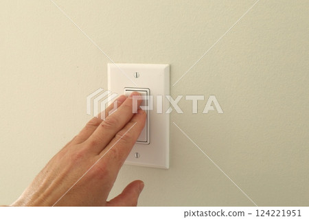 hand pressing wall light switch hand pressing wall light switch 124221951