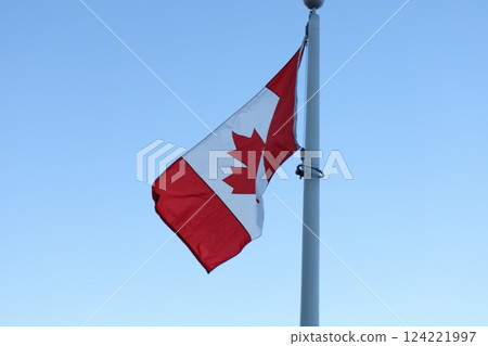 canadian flag against bright blue sky canadian flag against bright blue sky 124221997