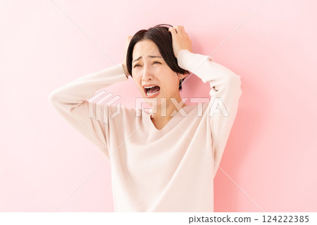 Woman shocked holding head 124222385