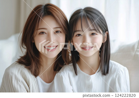 A cute teenage girl in junior high school and her mother in her 40s. Smiling Japanese parents and children 124222820