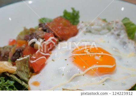 Taco rice topped with a fried egg Taco rice topped with a fried egg 124223912