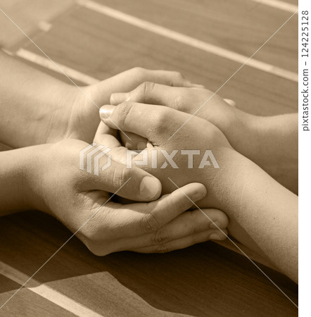 Close-up view of comforting hands Close-up view of comforting hands 124225128