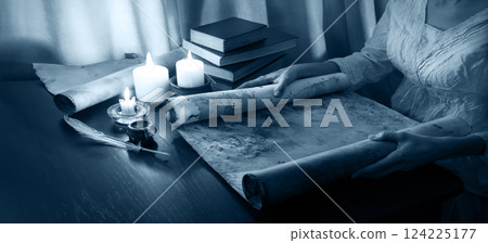 Hands with an old  scroll 124225177