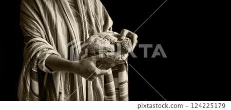 Human hands breaking fresh bread Human hands breaking fresh bread 124225179