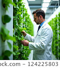 Close-up of a businessman using a tablet in front of an industrial facility, emphasizing digitalization in industry. 124225803