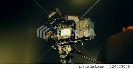Film or video production setup with high end professional cinema cameras lighting camera rig and crew members working on set. Behind the scenes or BTS video shoot in a studio for cinematic visuals. 124225998