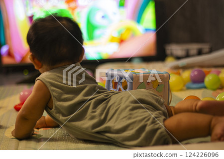 Baby In Bodysuit Is Crawling On A Soft Mat 124226096