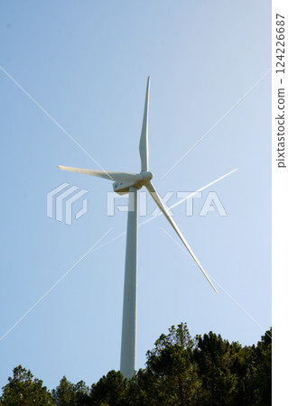 Wind turbine with blue sky at background 124226687