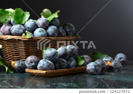 Blue plums on the kitchen table. 124227672