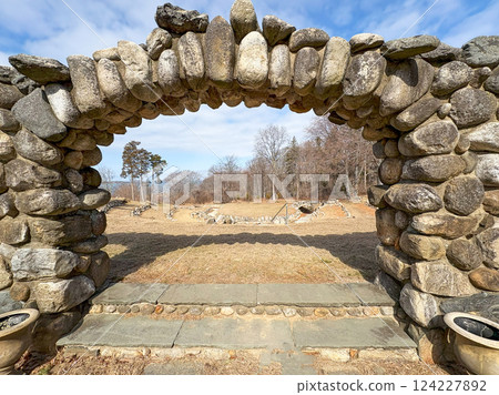 Stone Archway Framing a Serene Landscape on a Sunny Day on Long Island Stone Archway Framing a Serene Landscape on a Sunny Day on Long Island 124227892