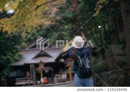Asian woman discovers the spiritual essence of Japanese shrines and temples, radiating happiness, faith, and cultural appreciation in Tokyo and Kyoto. 124228449