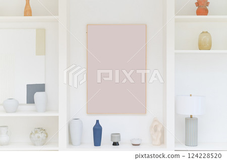 white shelf with blank art frame and vase 124228520