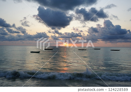 Sunrise over Indian Ocean and fishing boats in African Zanzibar island in Tanzania 124228589