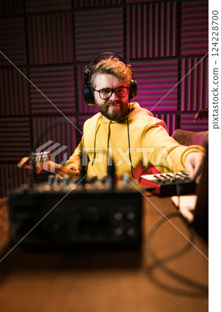 Sound engineer working at mixing panel in the boutique recording studio. Sound engineer working at mixing panel in the boutique recording studio. 124228700