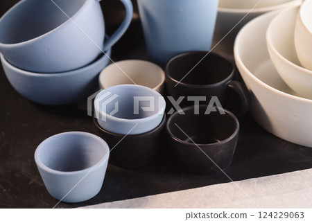 Matt ceramic handmade tableware in a workshop closeup 124229063