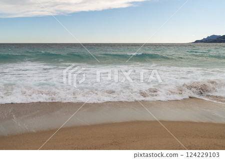 Sand beach of South France during spring with sea waves Sand beach of South France during spring with sea waves 124229103