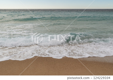 Empty sand beach on Mediterranean sea with horizon line vacation background Empty sand beach on Mediterranean sea with horizon line vacation background 124229104