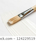 Paintbrush with white paint. 124229519