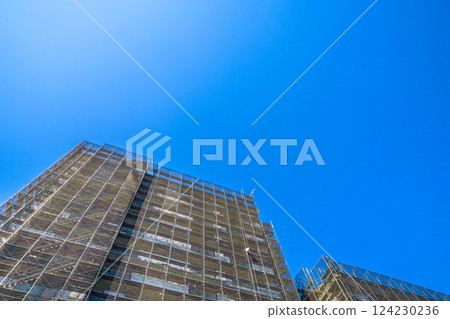 Yokohama cityscape in Japan - View of scaffolding and protective netting set up for repairs and inspections of apartment buildings (C) = Yokohama City 124230236