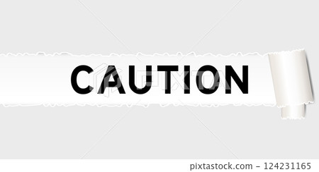Ripped gray paper background that have word caution under torn part 124231165