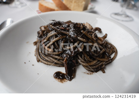 Squid ink pasta. Spaghetti with black squid ink sauce. 124231419