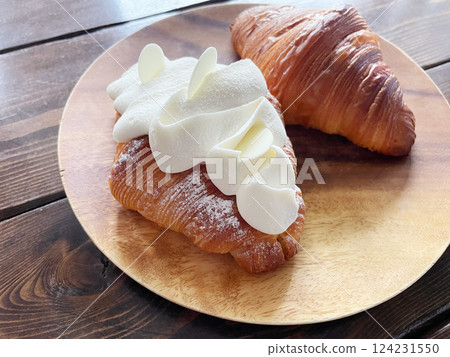 Croissant topped with cream; fluffy whipped cream dessert bread Croissant topped with cream; fluffy whipped cream dessert bread 124231550